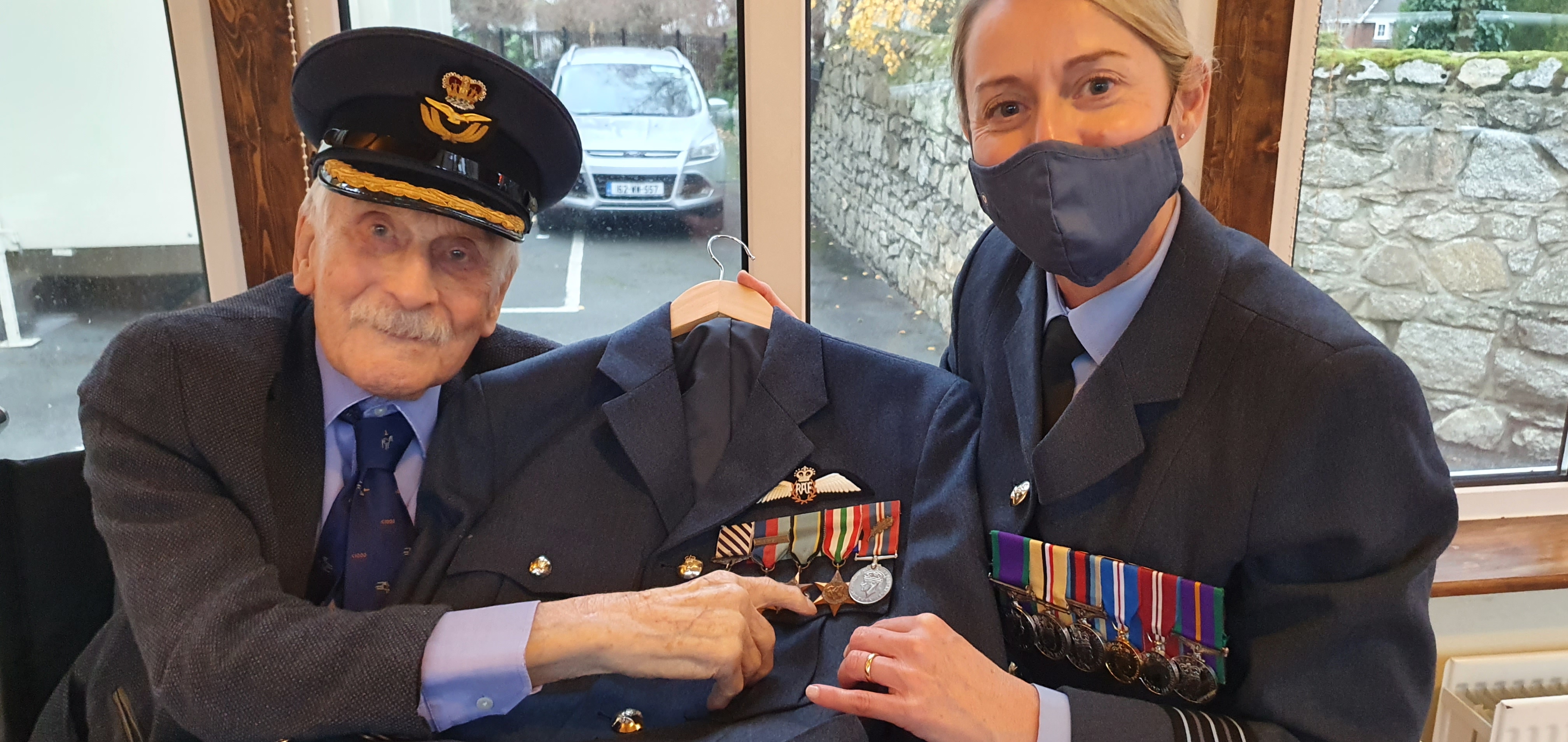 John and Wing Commander Rankin hold the restored uniform and medals.